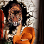 Wall murals Tiger emerging through cracked wall.