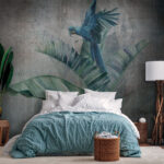 Wall murals Blue parrot perched on leafy branch.