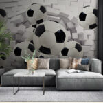 Wall murals Soccer balls breaking through wall.