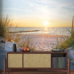 Wall murals Grass on a beach with water in the background