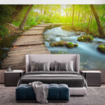 Wall murals Wooden bridge over rocks in a river