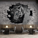 Wall murals Tiger breaking through white brick wall.