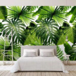 Wall murals Lush green tropical leaves pattern.