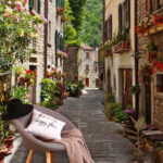 Wall murals Charming alley with vibrant flowers