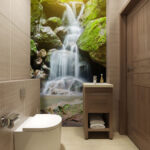 Wall murals Serene waterfall amidst lush greenery.