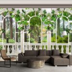 Wall murals White door with white flowers and green leaves