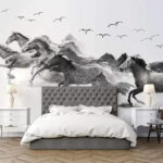 Wall murals Group of horses running through water