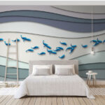 Wall murals Group of blue fish swimming in a group of waves