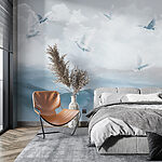Wall murals Group of white birds flying over a mountain