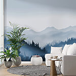 Wall murals Foggy mountain landscape with trees and mountains